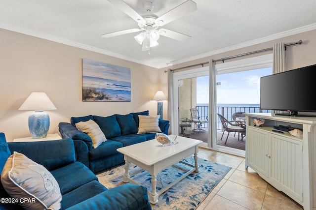 tiled living room featuring crown molding, a water view, and ceiling fan