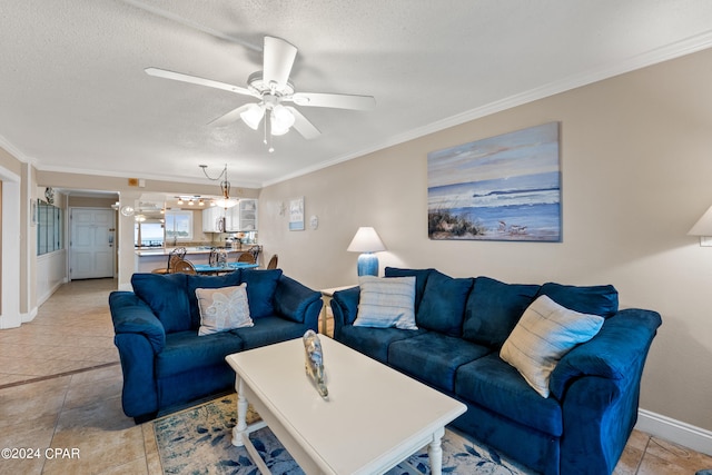 tiled living room with a textured ceiling, ornamental molding, and ceiling fan with notable chandelier