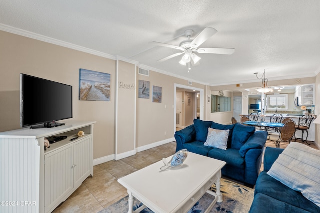 living room with light tile floors, a textured ceiling, ceiling fan, and ornamental molding