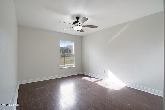 spare room with ceiling fan and dark wood-type flooring