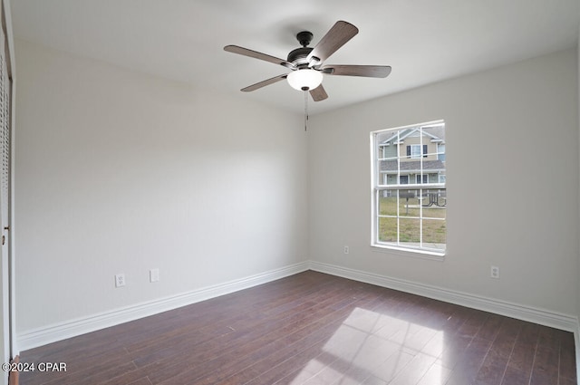 empty room featuring ceiling fan and dark hardwood / wood-style flooring