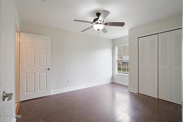 unfurnished bedroom featuring a closet, ceiling fan, and dark wood-type flooring