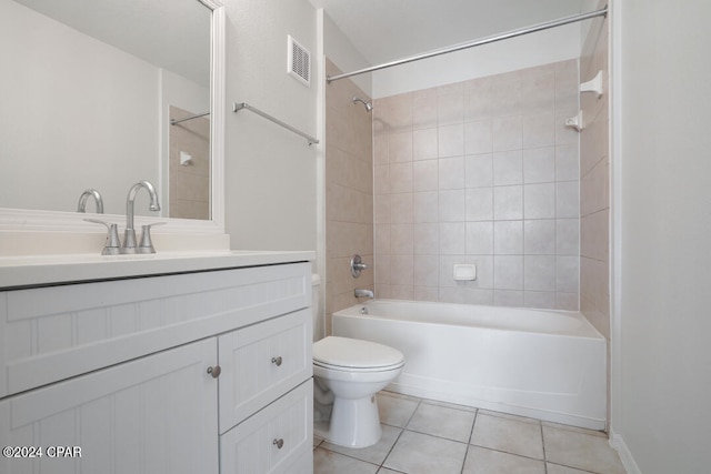 full bathroom featuring toilet, vanity, tiled shower / bath, and tile flooring