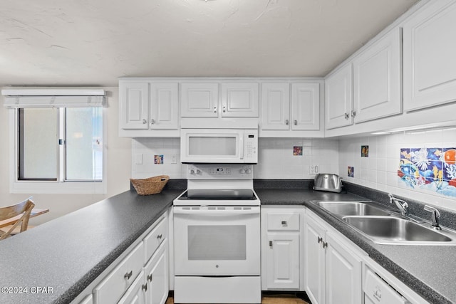 kitchen with white cabinets, white appliances, and tasteful backsplash