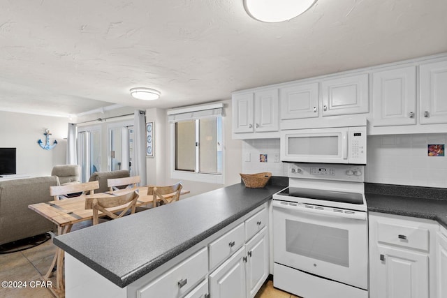 kitchen featuring white appliances, crown molding, tasteful backsplash, white cabinets, and light tile floors