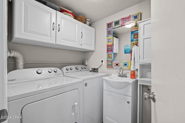 washroom with cabinets, sink, separate washer and dryer, and hookup for a washing machine