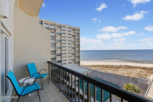 balcony featuring a water view and a view of the beach