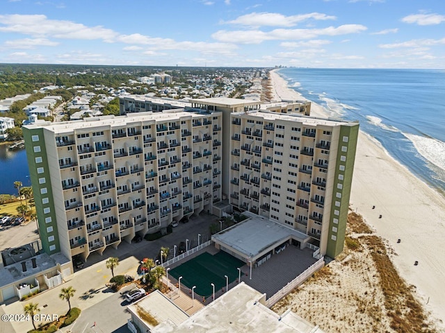 bird's eye view with a water view and a beach view