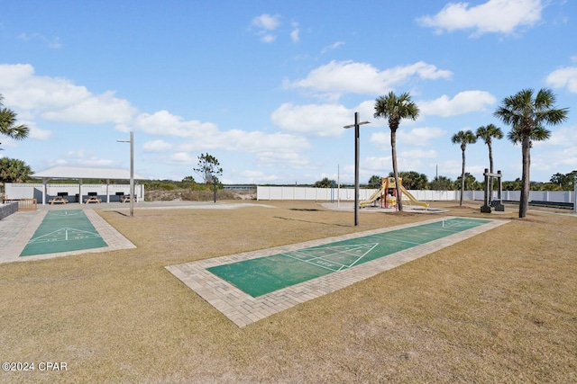 surrounding community featuring a playground and a lawn