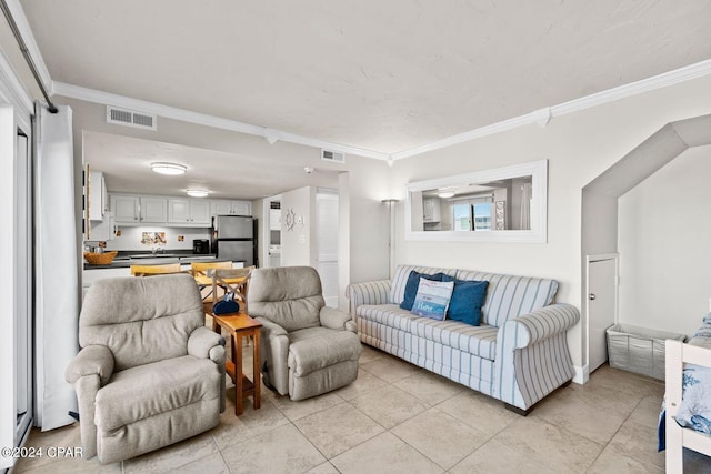 living room featuring ornamental molding and light tile floors