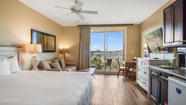 bedroom featuring sink, wood-type flooring, ceiling fan, and access to exterior