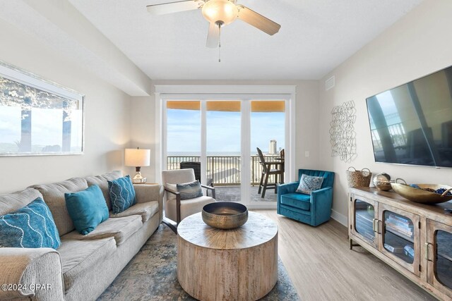 living room featuring ceiling fan and hardwood / wood-style flooring