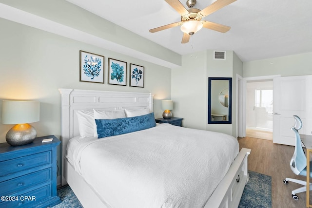 bedroom with dark wood-style floors, ceiling fan, and visible vents