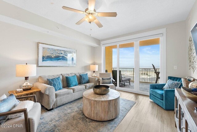 living room with ceiling fan and light hardwood / wood-style floors