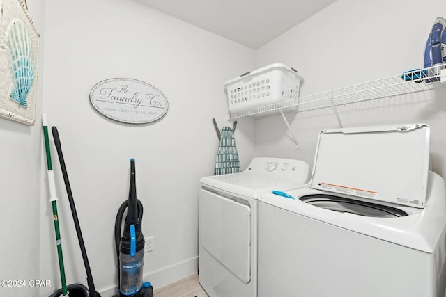 laundry area featuring washing machine and dryer, laundry area, and baseboards