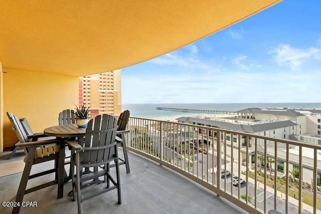 balcony featuring a beach view and a water view