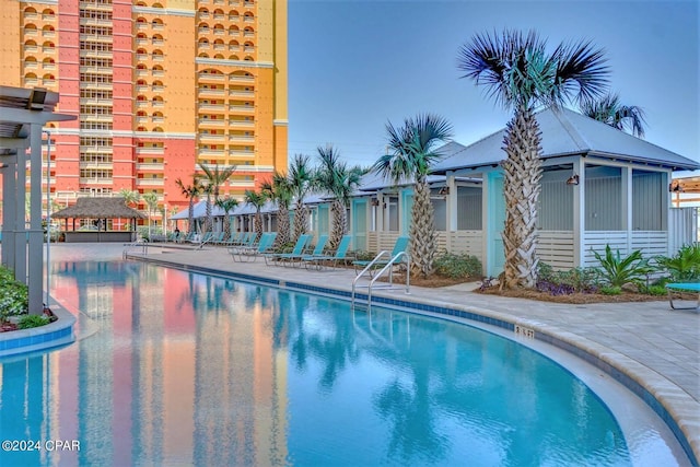 community pool featuring a patio area and fence