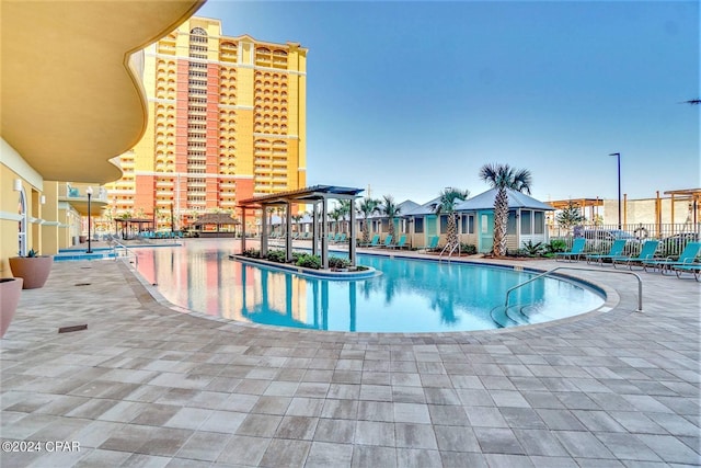 pool featuring fence, a pergola, and a patio