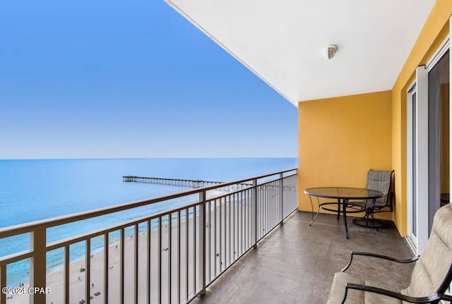 balcony featuring a water view and a view of the beach