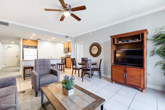 living room with ornamental molding, ceiling fan, and light tile floors