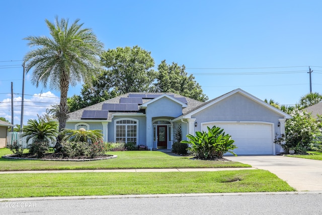 ranch-style house with a front yard, a garage, and solar panels