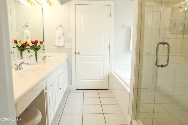 bathroom featuring vanity with extensive cabinet space, separate shower and tub, and tile floors