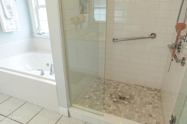 bathroom featuring tile flooring and shower with separate bathtub