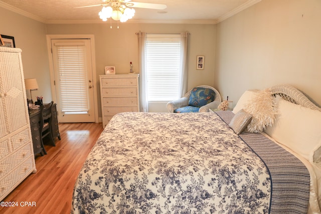 bedroom featuring hardwood / wood-style floors, a closet, ceiling fan, and crown molding