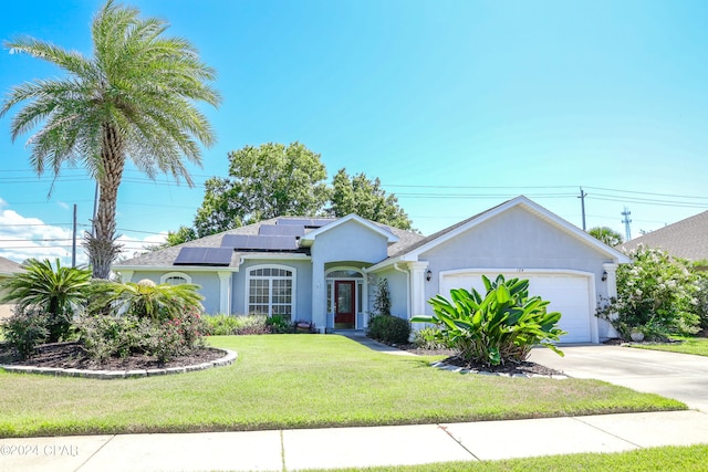 single story home with a garage, a front yard, and solar panels