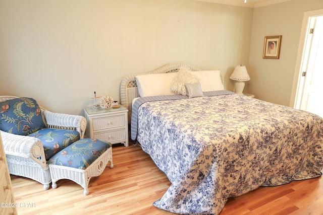 bedroom featuring ornamental molding and wood-type flooring