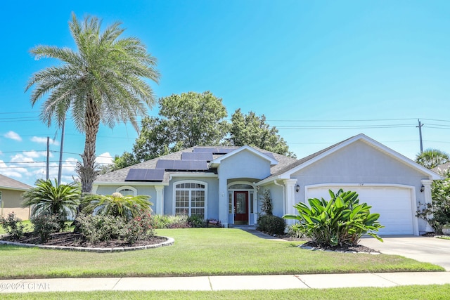 ranch-style home featuring a front lawn, a garage, and solar panels