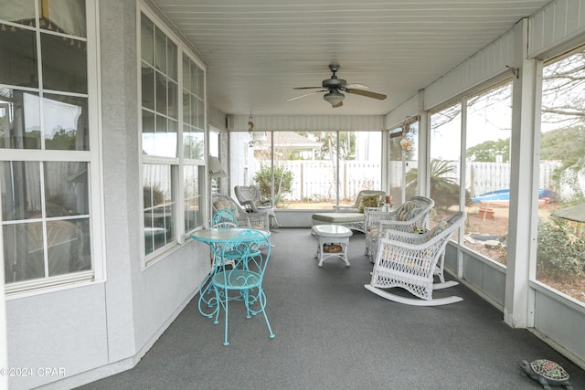 unfurnished sunroom with ceiling fan