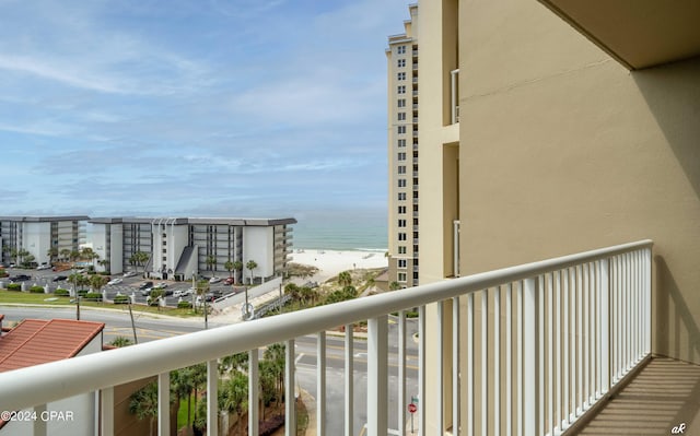 balcony featuring a water view and a beach view