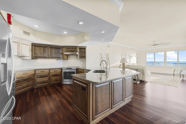 kitchen with decorative backsplash, dark hardwood / wood-style floors, sink, crown molding, and stainless steel appliances