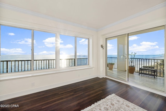 unfurnished sunroom with a water view