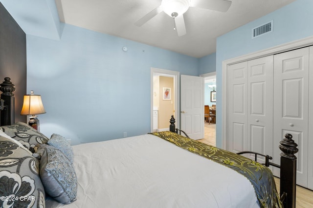 bedroom featuring ceiling fan, a closet, and light wood-type flooring