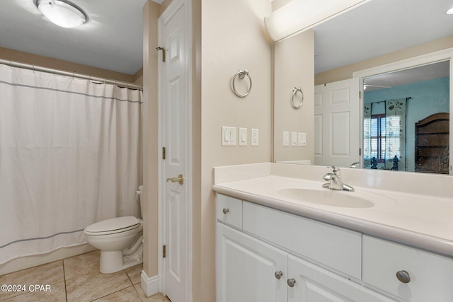 bathroom featuring toilet, vanity, and tile patterned floors