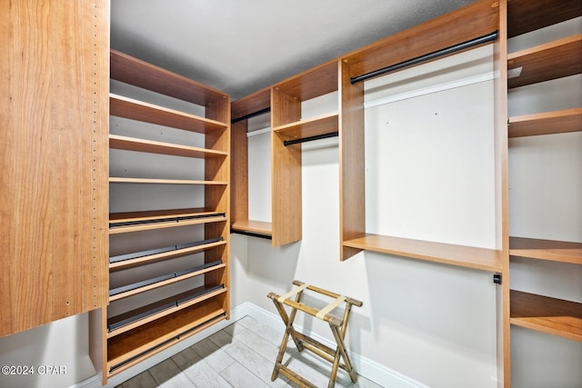 spacious closet featuring light wood-type flooring