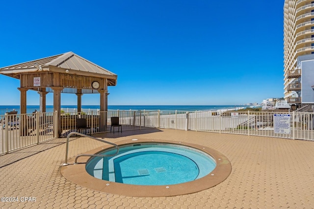 view of swimming pool with a water view and a community hot tub