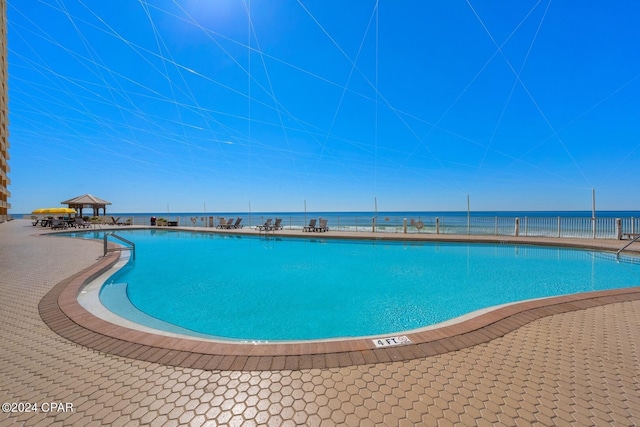 view of pool featuring a water view