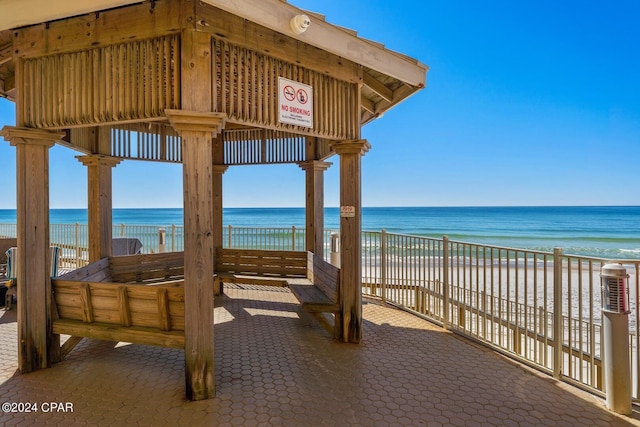 view of patio / terrace featuring a view of the beach and a water view