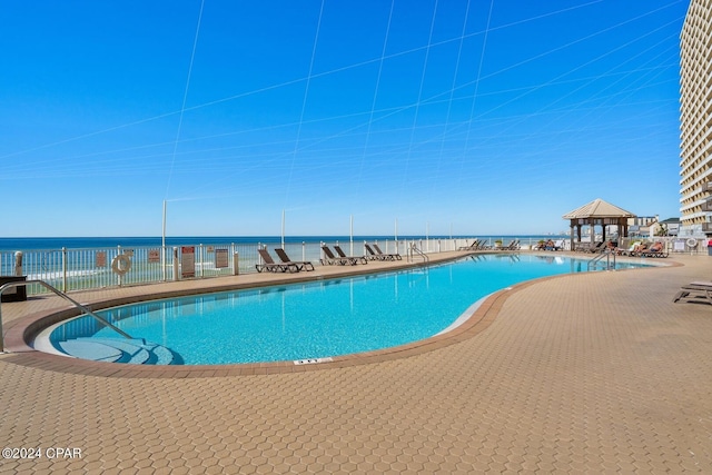 view of pool featuring a water view