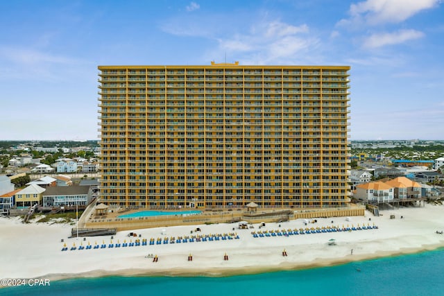 exterior space featuring a water view and a beach view