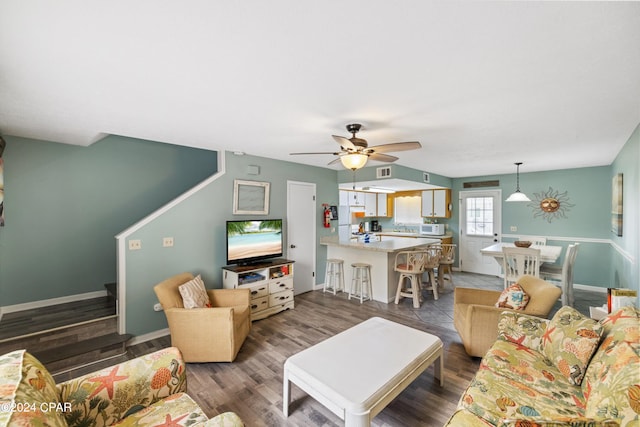 living room featuring ceiling fan and hardwood / wood-style flooring