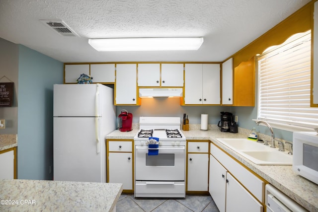 kitchen featuring light tile flooring, extractor fan, white cabinetry, sink, and white appliances