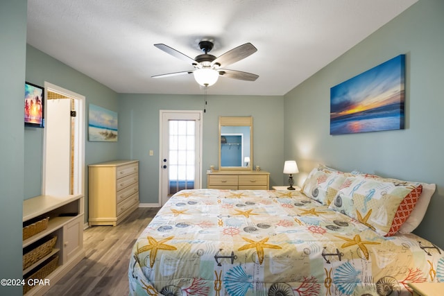 bedroom with ceiling fan and hardwood / wood-style flooring