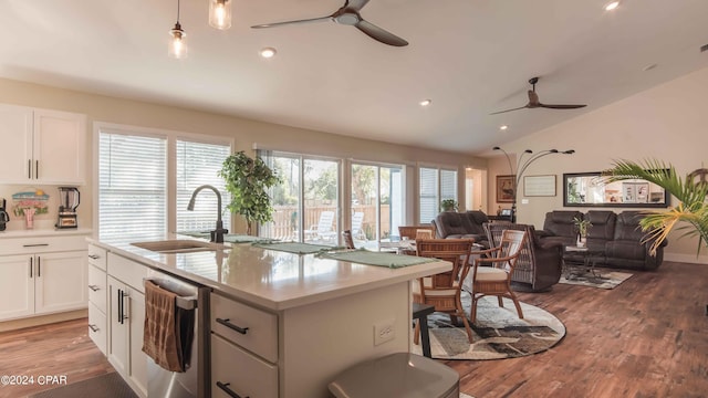 kitchen with ceiling fan, white cabinetry, dishwasher, and hardwood / wood-style flooring