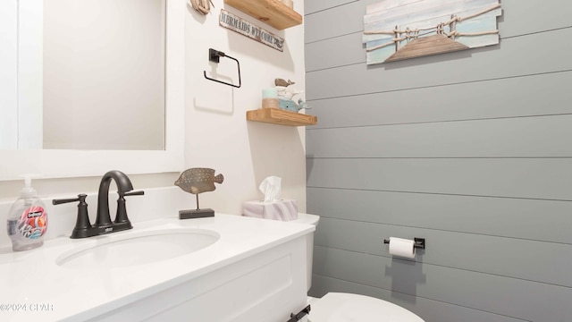 bathroom featuring large vanity and toilet