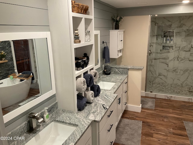 bathroom with walk in shower, wood-type flooring, and dual vanity