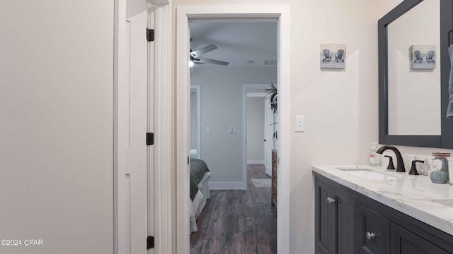 bathroom with vanity, ceiling fan, and hardwood / wood-style flooring